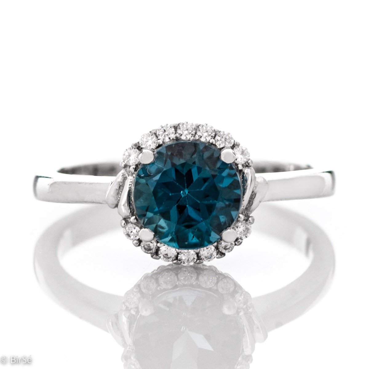 Delicately elegant women's ring made entirely of rhodium-plated silver, exquisite London topaz and the sparkle of fine zircons. It is suitable for combining in a set with earrings and a pendant from the same stylish collection.