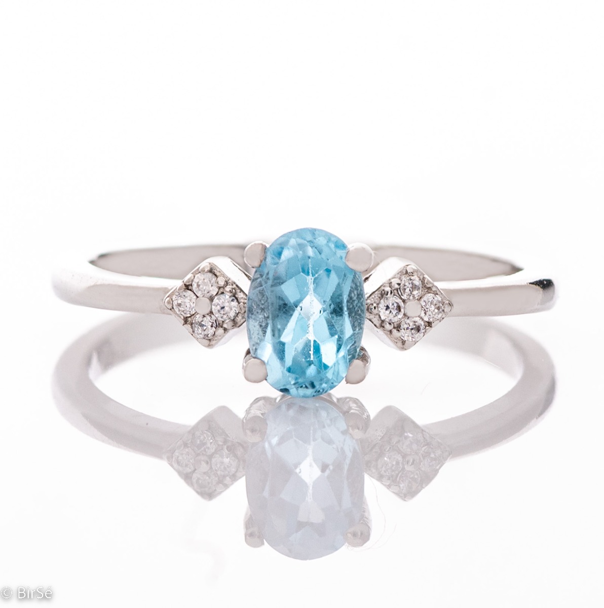 An exquisite silver ring with a delightful design. A spectacular look based on the charm of sky blue topaz in the company of sparkling zircons.