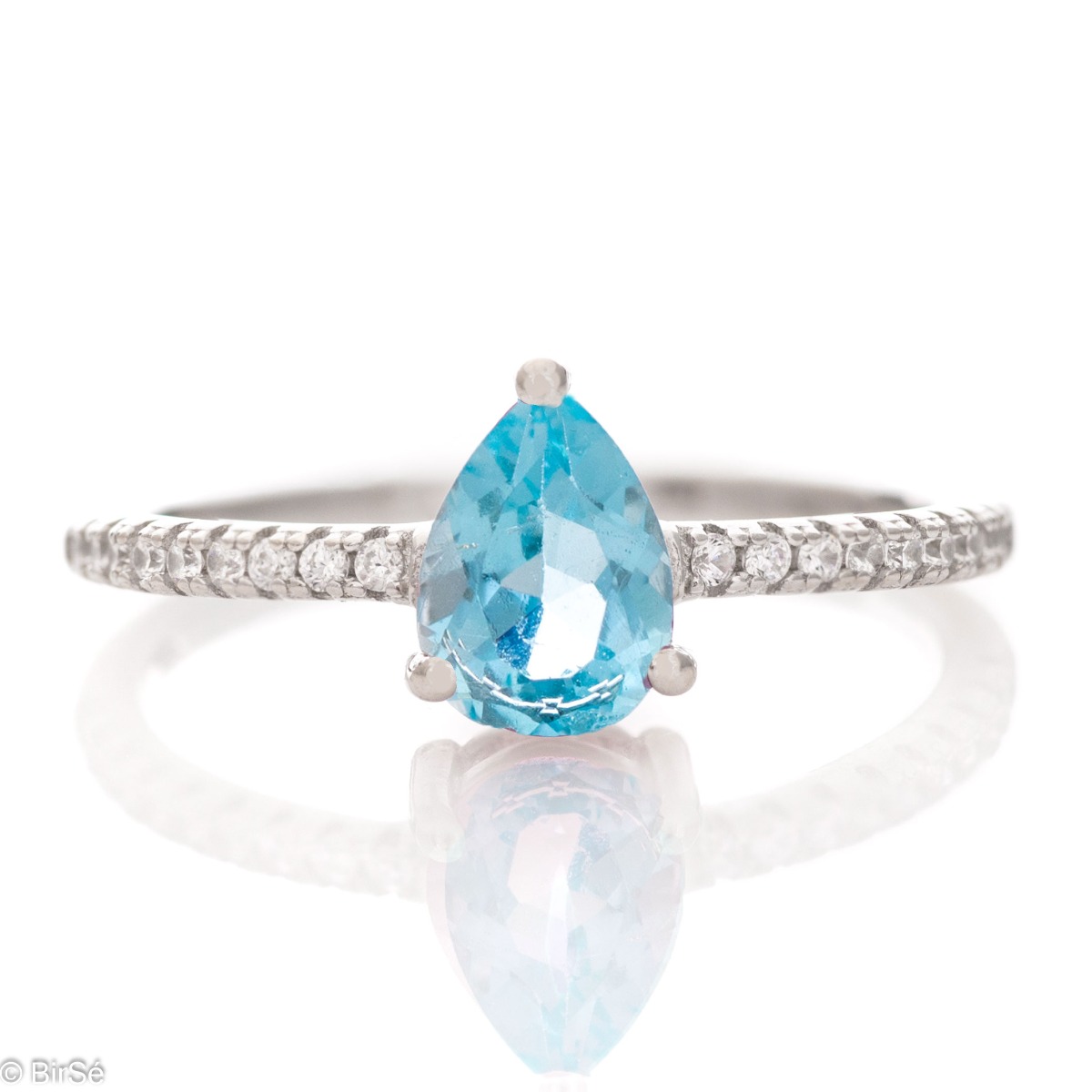 An extremely delicate ladies' ring with an elegant combination of shiny rhodium-plated silver with a natural blue topaz stone and fine zircons. A drop of soft blue lake water will adorn your hand, and complete with a necklace and earrings from the model y