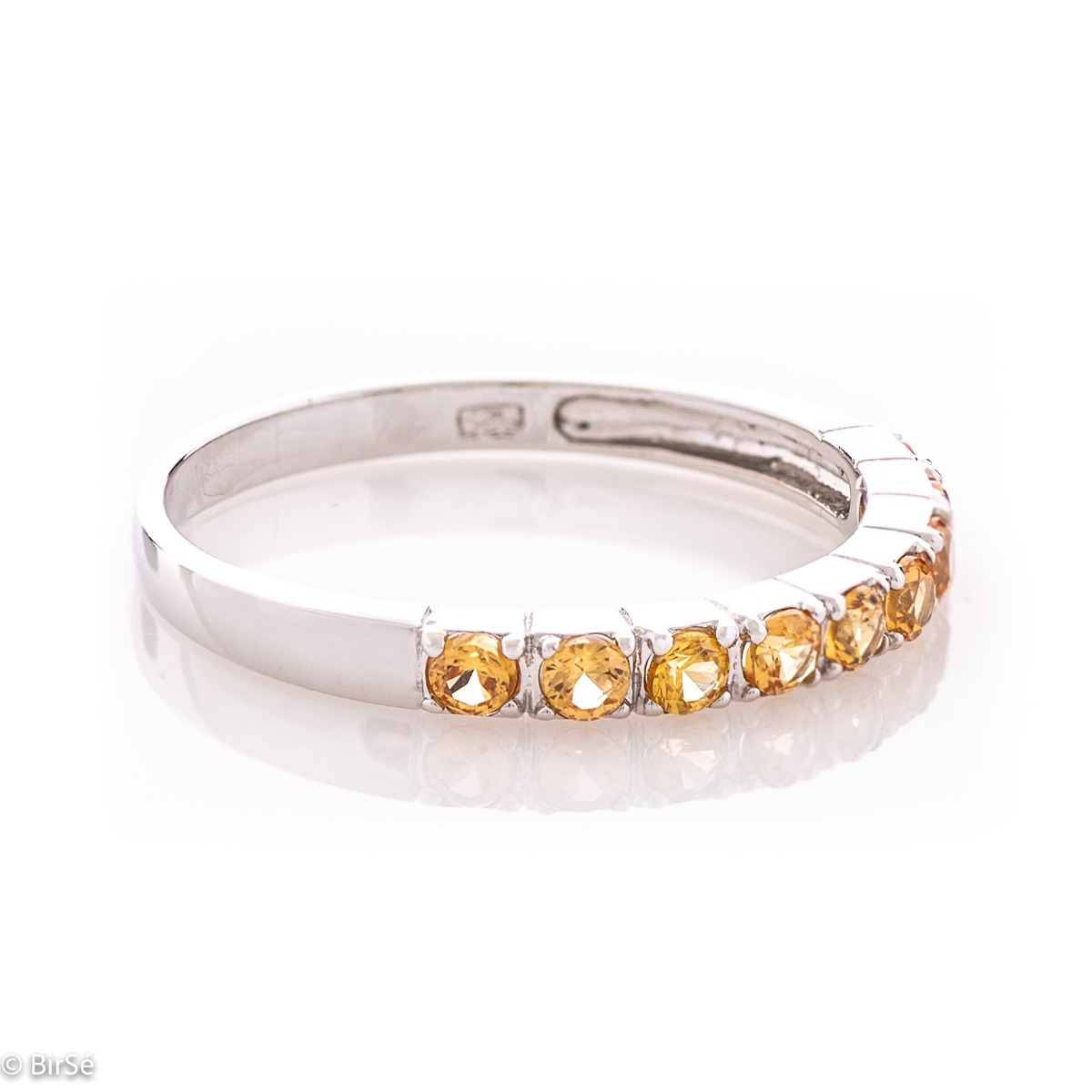 A delightfully charming ring in exquisite rhodium-plated silver with a row of enchanting citrine stones.