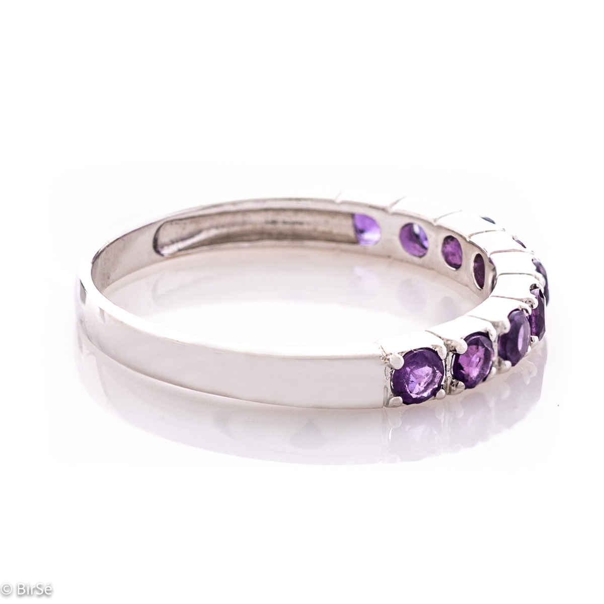 Delicate tempting ring in fine rhodium silver with a row of lovely amethyst stones.