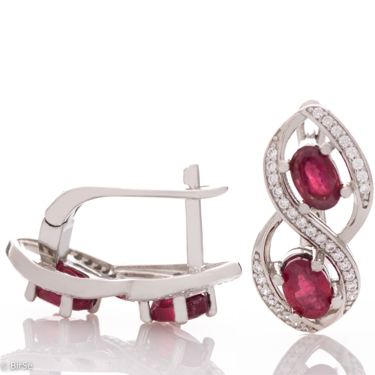 Stunning infinity rhodium silver rhodium-plated sterling silver earrings exquisitely embellished with sparkling cubic zirconias encircling royal rubies. Complete with a ring of the same design.