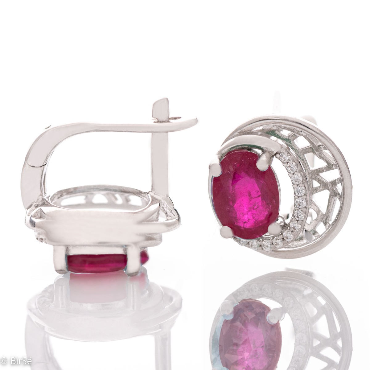 Elegant silver earrings with a modern look and English clasp. Stylish designer craftsmanship from a fine combination of rhodium-plated silver with captivating natural rubies. Complete with silver pendant and silver ring from the same collection.