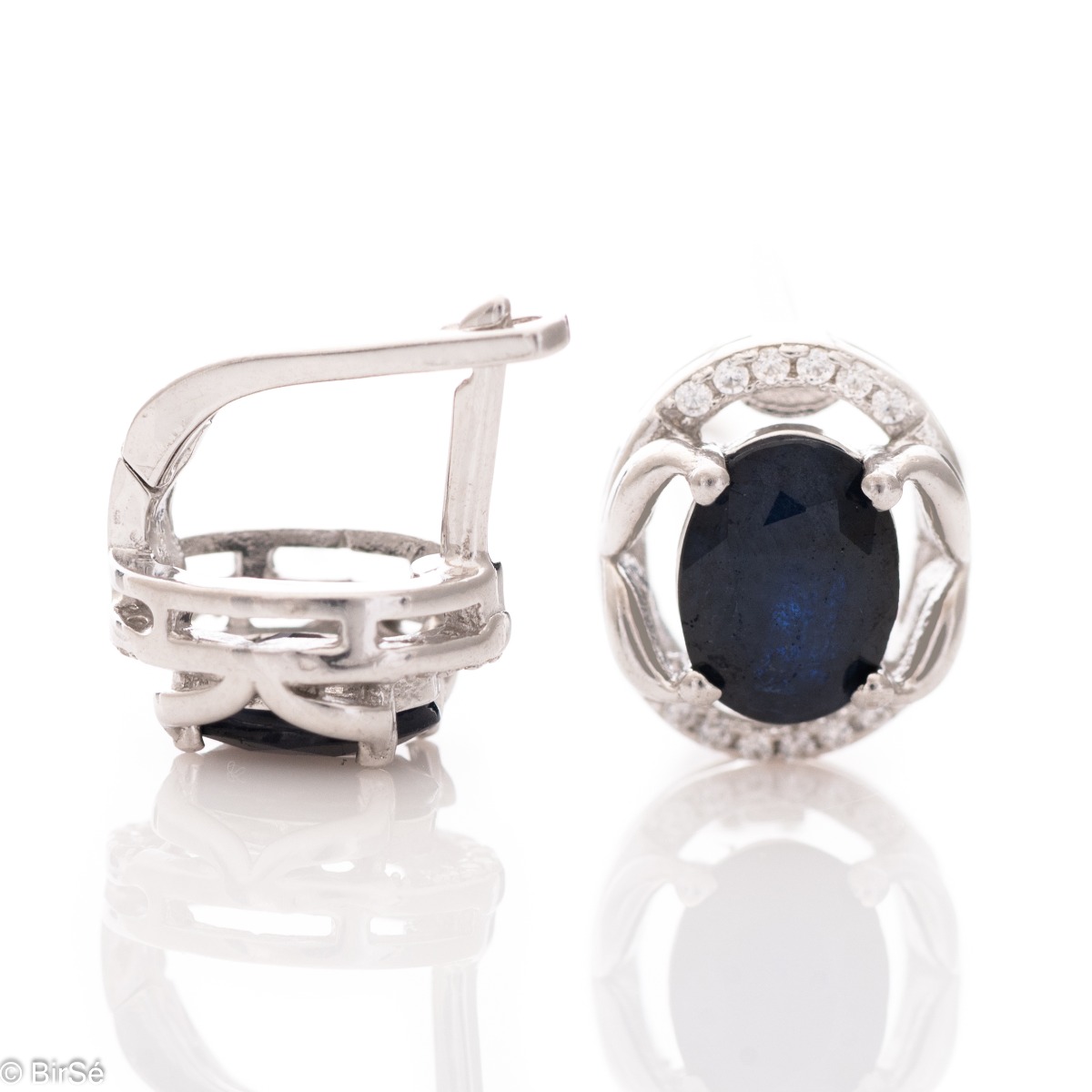 A royal vision - elegant silver earrings with a delicate design. Stylish composition made of a fine combination of rhodium-plated silver with sparkling zircon stones and exquisite sapphire. In a lovely ring and pendant set from the model.