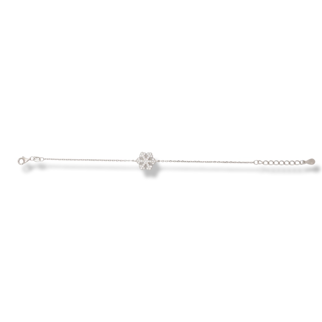 An elegant bracelet in fine rhodium silver with an exquisite snowflake design, beautifully encrusted with sparkling zircons. The bracelet has an extension for convenient length adjustment.