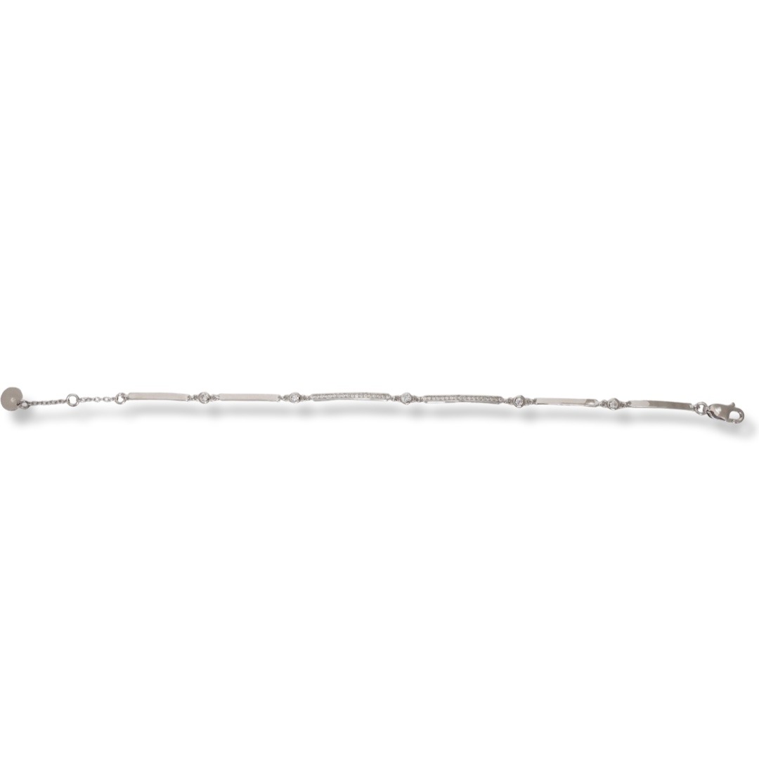 An elegant model of a rhodium silver bracelet for women with a simple design of the elements decorated with zircons. The delicate ladies' bracelet is a great gift idea for any lady. The bracelet has an added chain to increase the length.