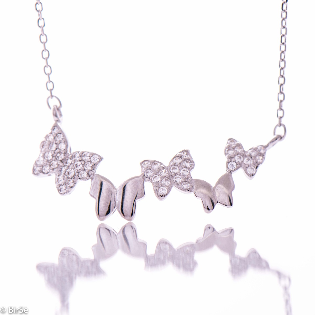 Delicate and elegant silver necklace in the form of exquisite butterflies, floating in an ethereal dance. Stylish composition of a fine combination of rose silver and zircon stones.