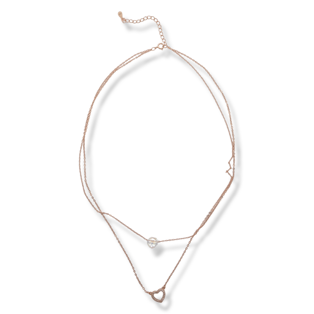 Elegant women's necklace with an exquisite design in rose silver with two delicate hearts. The jewelry has a double chain. A magnetic heart-shaped zircon dances charmingly on one, and on the second the heart is made of silver with added fine stones.