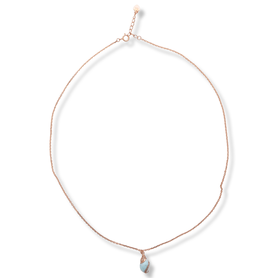 Delicate women's necklace with a delicate rose silver pendant design. The jewelry features an elegant chain holding an exotic element with a captivating sea blue opal and added fine zircons.