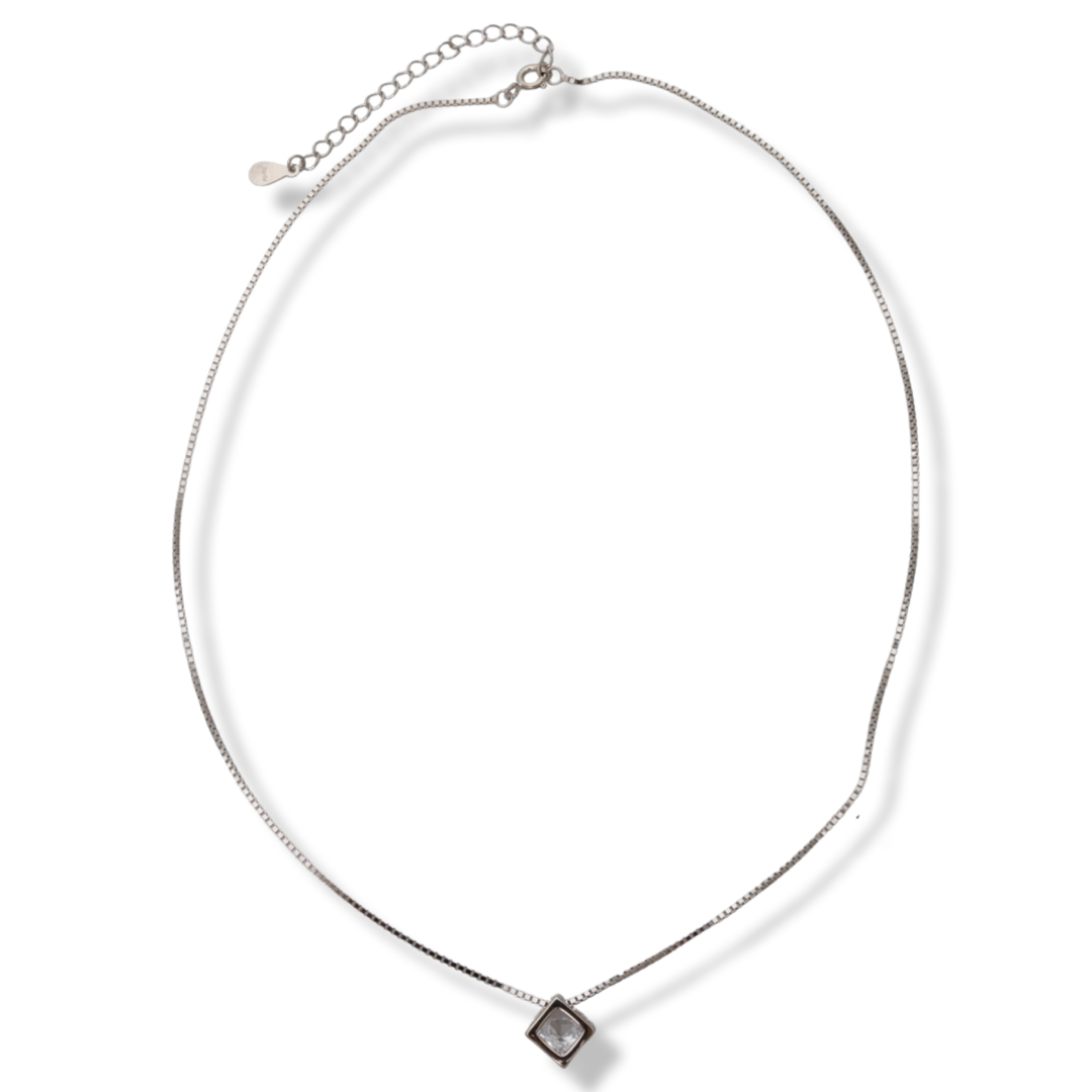 Elegant women's necklace with a modern design made of rhodium silver. The jewelry has a captivating craftsmanship - a delicate chain of classic Venetian braid, holds a cube-shaped element, elegantly enclosing a dazzling zircon.