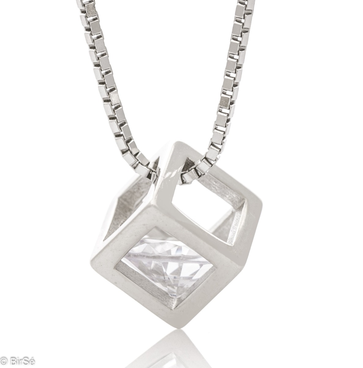 Elegant women's necklace with a modern design made of rhodium silver. The jewelry has a captivating craftsmanship - a delicate chain of classic Venetian braid, holds a cube-shaped element, elegantly enclosing a dazzling zircon.