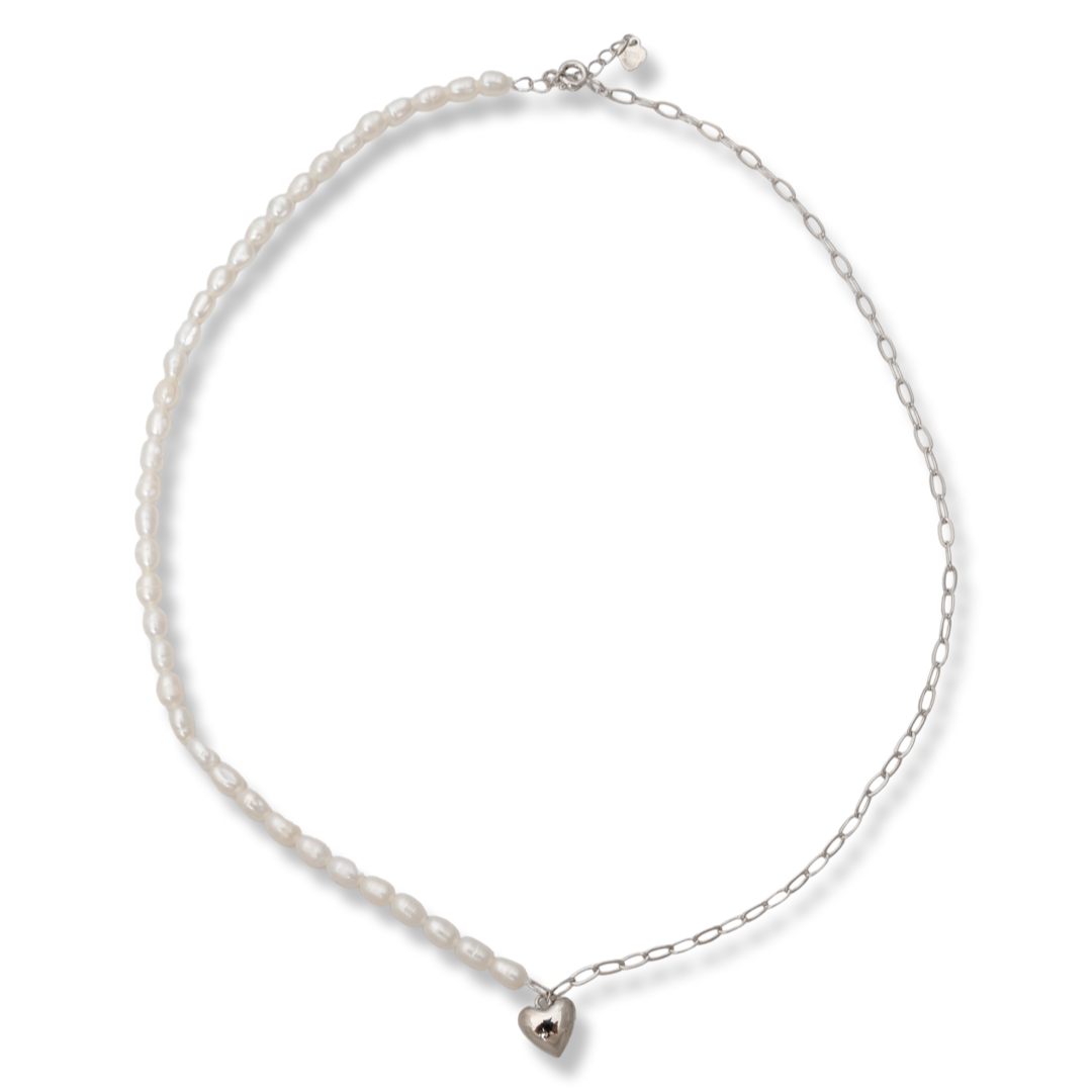 Perfectly crafted necklace for stylish ladies, executed by combining fine rhodium silver and captivating pearls charmingly covering one side of the chain. A delicate heart completes this tempting piece of jewelry, which is a perfect addition to any outfit