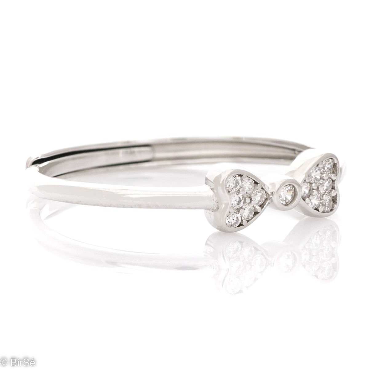 Delicately elegant silver ring with the shape of an exquisite ribbon. Stylish workmanship of the compositional elements and details of a fine overflow of rhodium silver with the sparkle of zircons. It is suitable for combining with silver earrings and pen