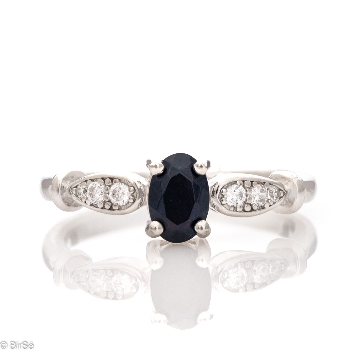 A refined and extremely elegant ring with an exquisite design look. Stylish craftsmanship of the elements and details from a fine combination of rhodium silver with tempting black opal. In an exclusive set with earrings and pendant.