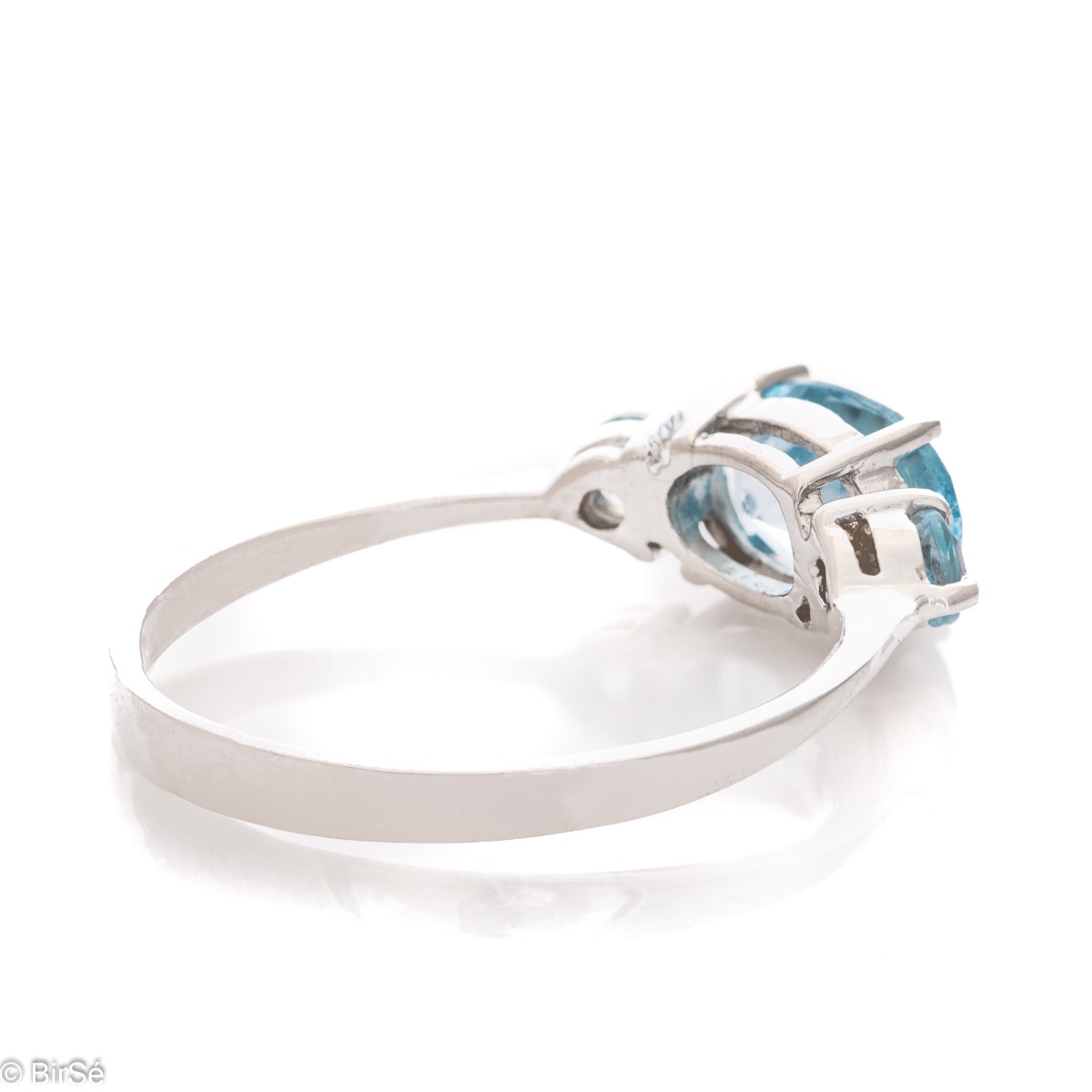 A stylish new offering for your jewelry collection. A ladies ring made entirely of fine rhodium silver that gently envelops a dazzling blue topaz.