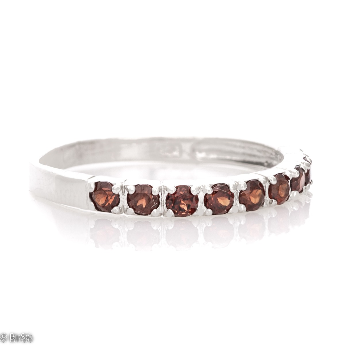 A sparkling ring with exquisite workmanship entirely in rhodium silver, a beautiful combination of delicate natural garnet stones, elegantly arranged in a row.