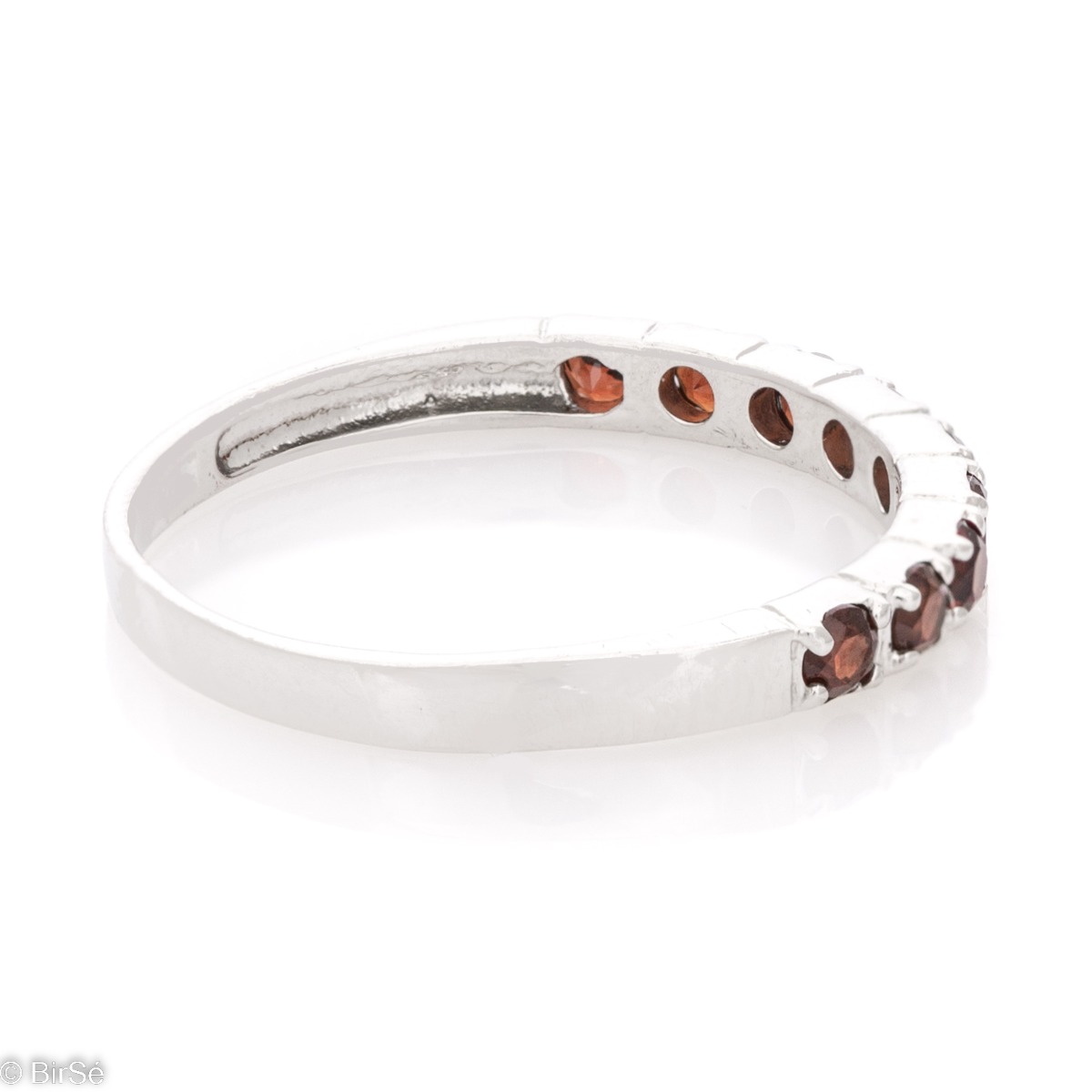 A sparkling ring with exquisite workmanship entirely in rhodium silver, a beautiful combination of delicate natural garnet stones, elegantly arranged in a row.