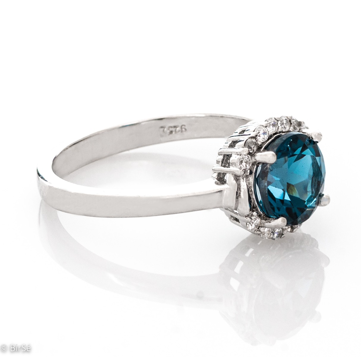 Delicately elegant women's ring made entirely of rhodium-plated silver, exquisite London topaz and the sparkle of fine zircons. It is suitable for combining in a set with earrings and a pendant from the same stylish collection.