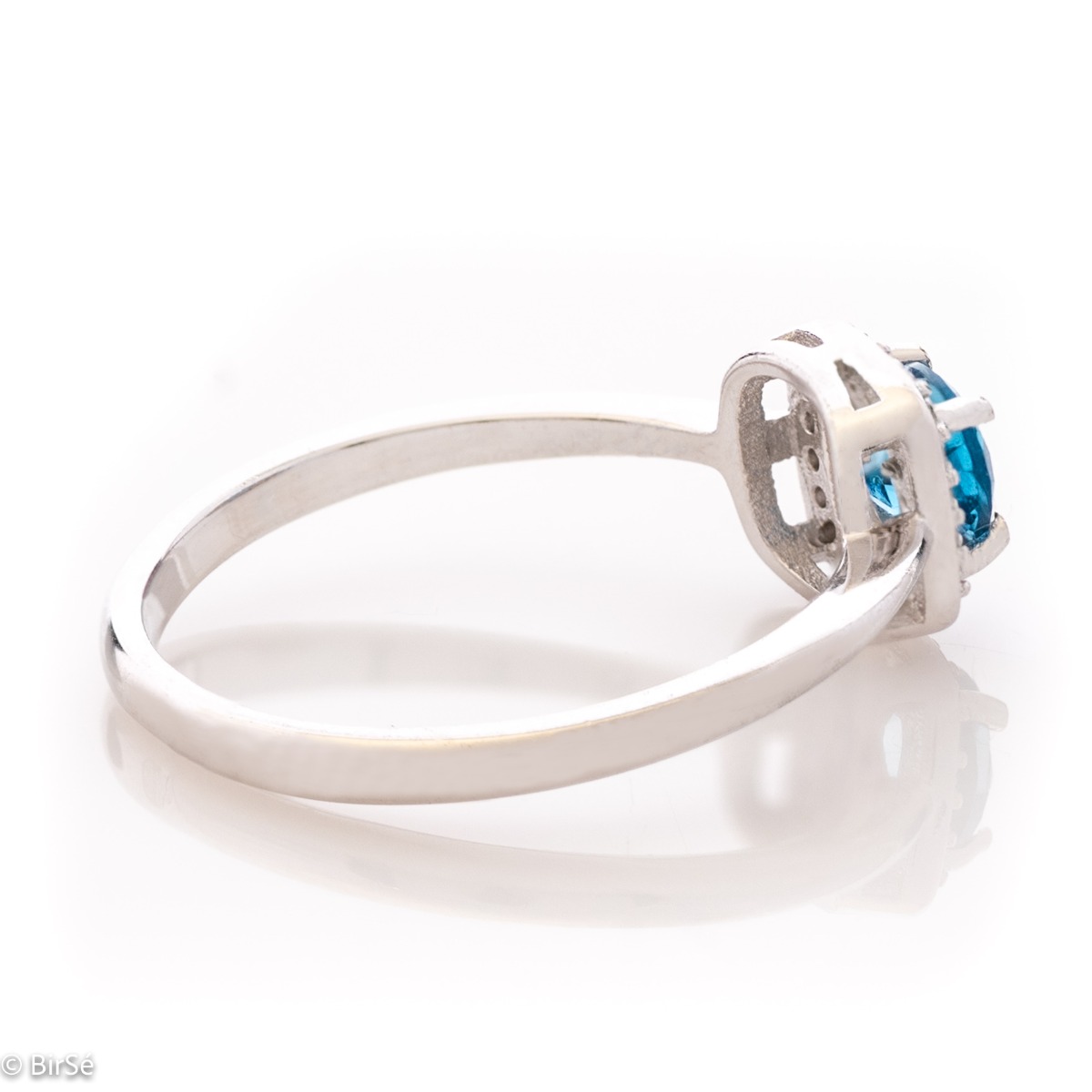 An elegant women's ring with extremely delicate details made of rhodium silver, natural London topaz and sparkling zircon stones. It is suitable for combining in a set with earrings and a pendant from the same collection and the same unique design.