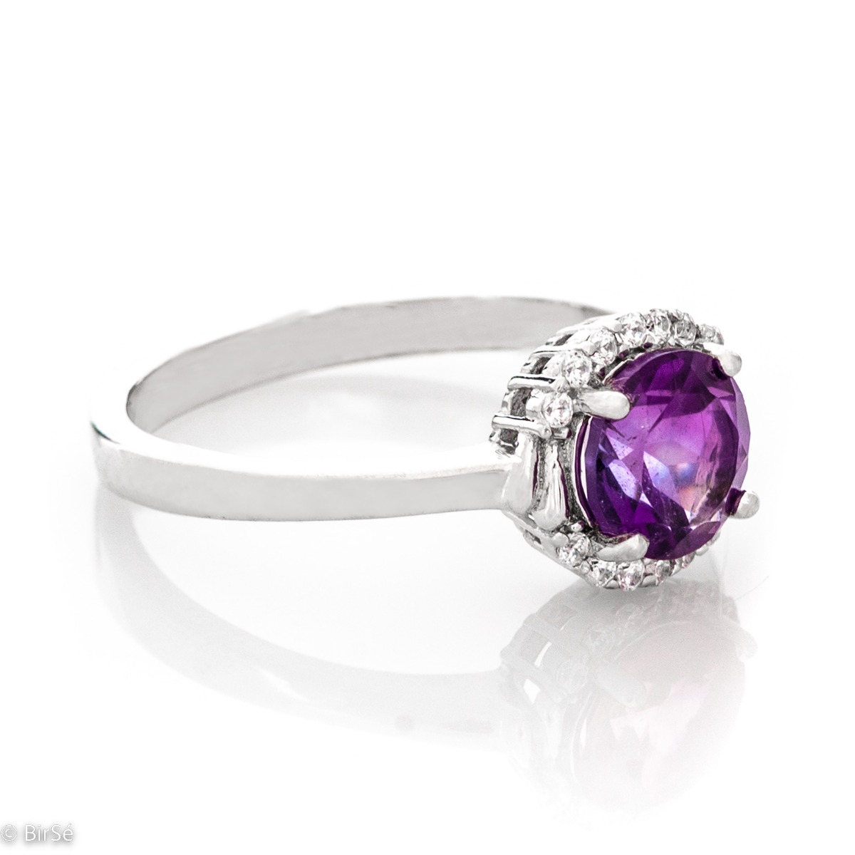 An elegant women's ring made of a delicate combination of rhodium-plated silver, natural amethyst and sparkling zircons. Part of a silver pendant and earring set from the same collection and the same striking design.