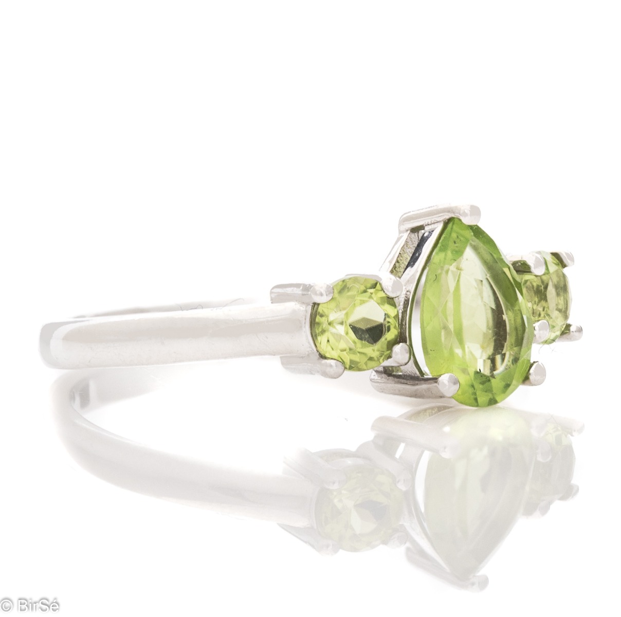 A delicate ring, finely crafted from rhodium-plated silver and a soft green teardrop-shaped peridot stone. Beautiful jewelry for stylish ladies.