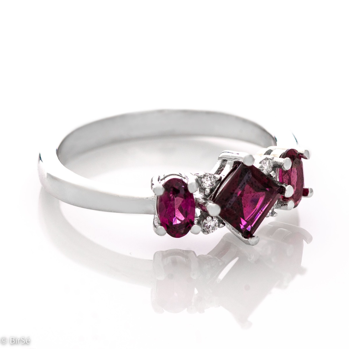 Spectacular, exquisitely crafted ring of rhodium-plated silver and natural rhodolite stones, in the refined mining of delicate zircons. Part of a charming set with stylish pendant and earrings from the same collection.