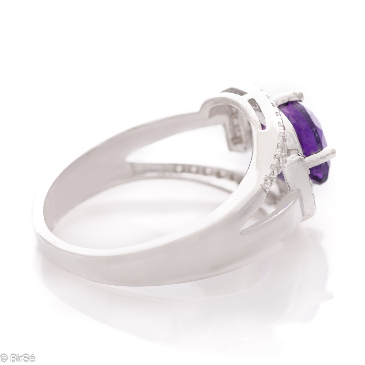 An elegant silver ring with an exquisite design, centered with a sparkling Amethyst, also known as the "Stone of Dreams". Delicate zircons add more sparkle to the jewelry.