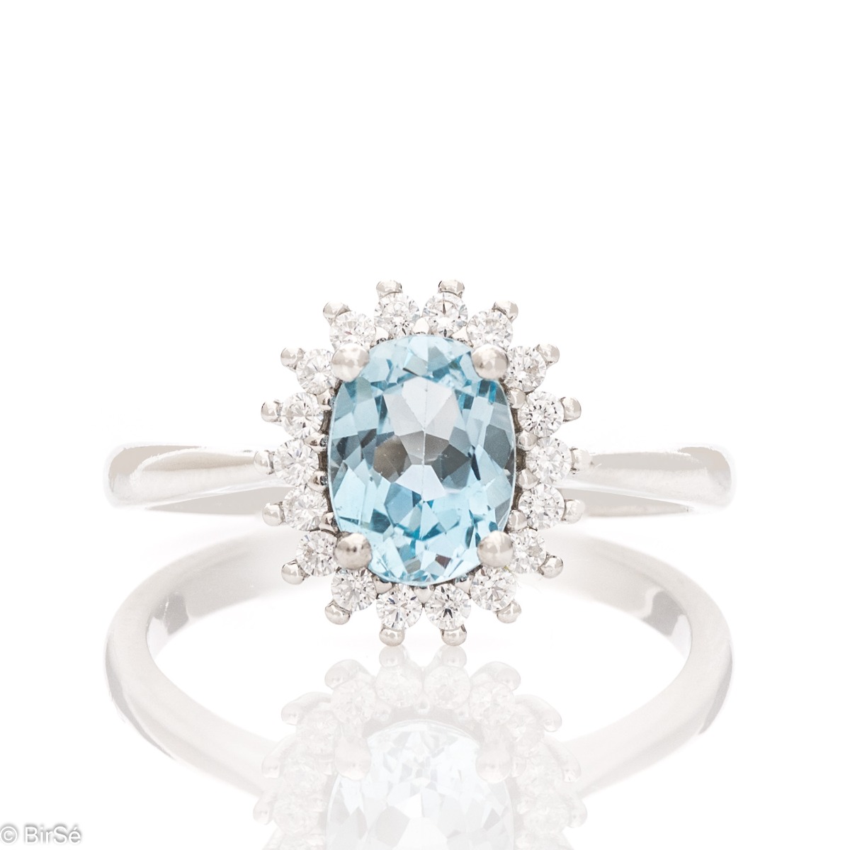 A radiant women's ring with delicate craftsmanship entirely made of rhodium-plated silver, complemented by a unique natural blue topaz stone and the sparkle of fine zircons. Part of an exclusive set with a delicate pendant and earrings.