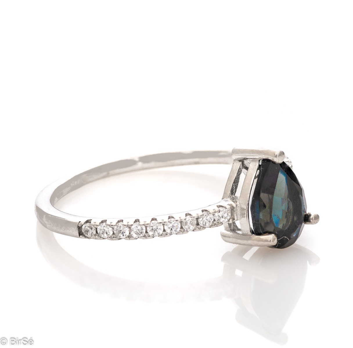 An exceptional women's ring with a radiant natural London topaz surrounded by fine sparkling zircons and exquisitely crafted entirely in rhodium-plated silver.