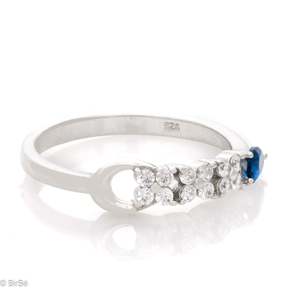 Elegant women's ring with exquisite rhodium-plated silver and radiant sapphire drop, in the company of sparkling zircons.