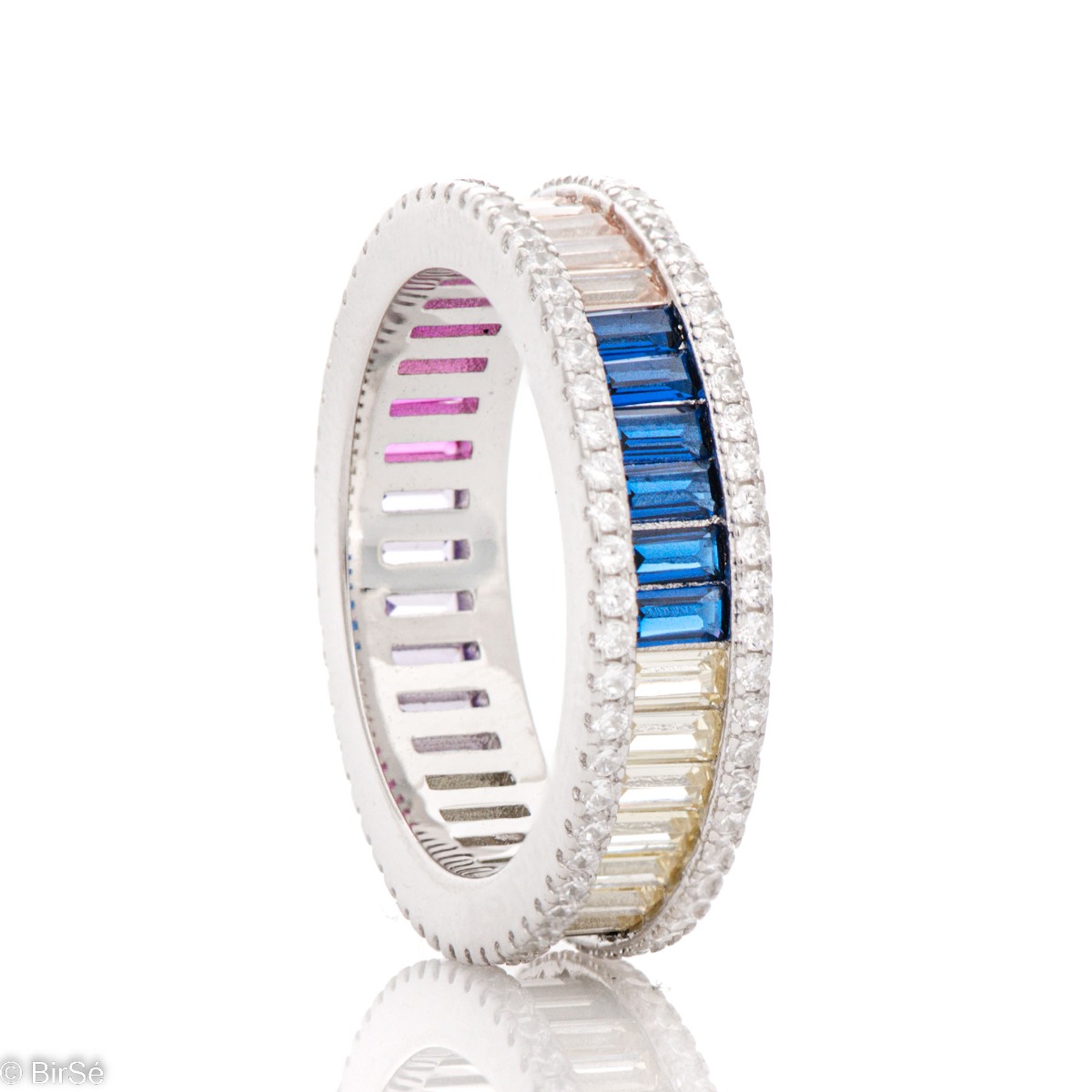 Sophisticated women's ring - rhodium-plated silver ring and baguette-shaped multi-colored zircons. The ring is completely surrounded by smaller zircons for even more sparkle. A suitable piece of jewelry for a special woman.