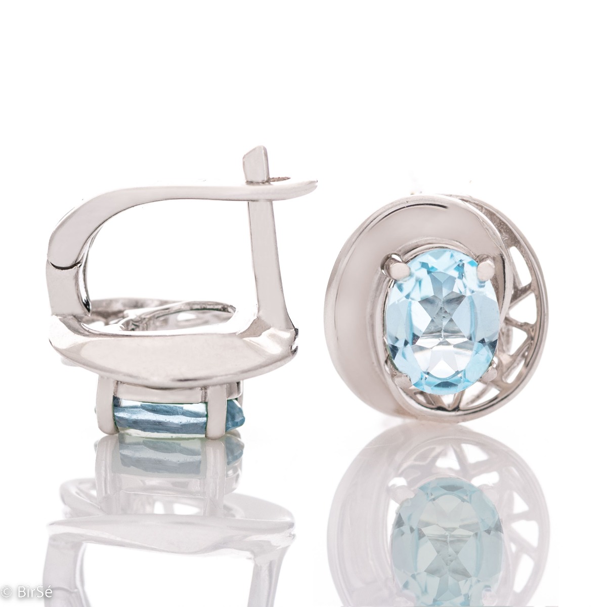 Dazzling rhodium-plated sterling silver and natural blue topaz earrings in an oval shape, encased in delicate hardware with an exquisite design. Make your look even more spectacular with a pendant and ring from the same collection.