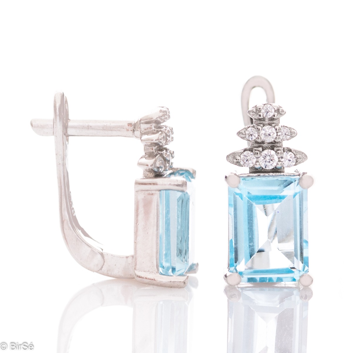 A fairy tale magic – delicate earrings made of rhodium silver with an English clasp. A combination of natural blue topaz and zircons in an elegant design.