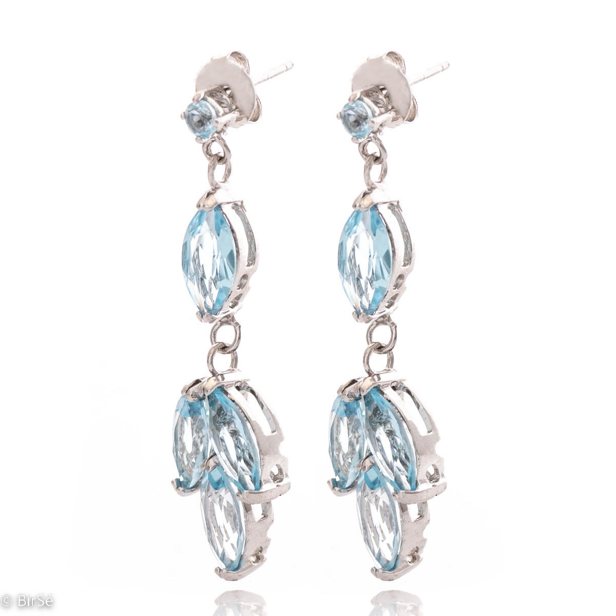 Elegantly crafted drop earrings of divinely beautiful blue topazes. The earrings are made of rhodium-plated silver, which, combined with the captivating topaz, will light up your face and give you a regal glow.