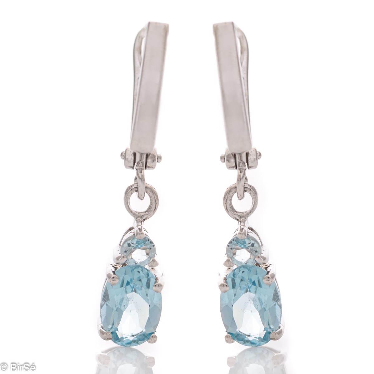 Elegant rhodium silver dangle earrings for every style - these are our earrings with a captivatingly delicate blue topaz. Elegance yourself or a loved one with the complete set, which includes a ring and pendant with the same lovely design.