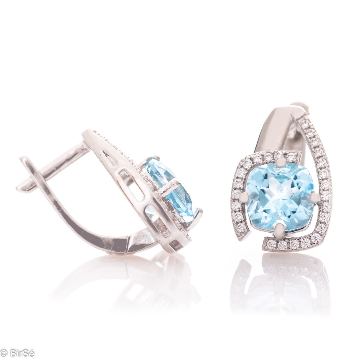 Elegant women's earrings with English clasp and radiant natural topaz, complemented by sparkling zircons and a stylish design entirely in rhodium silver.