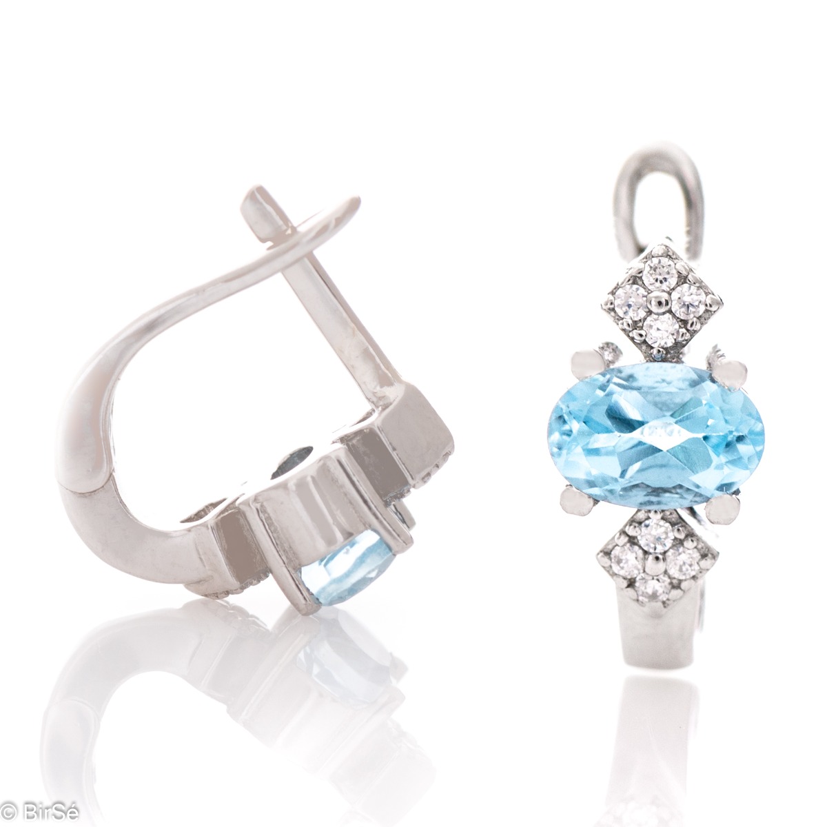 Extremely radiant ladies' English clasp earrings, combining the sparkle of delicate zircons with a natural blue topaz stone. Complemented with exquisite and fine workmanship entirely in beautiful rhodium-plated silver.