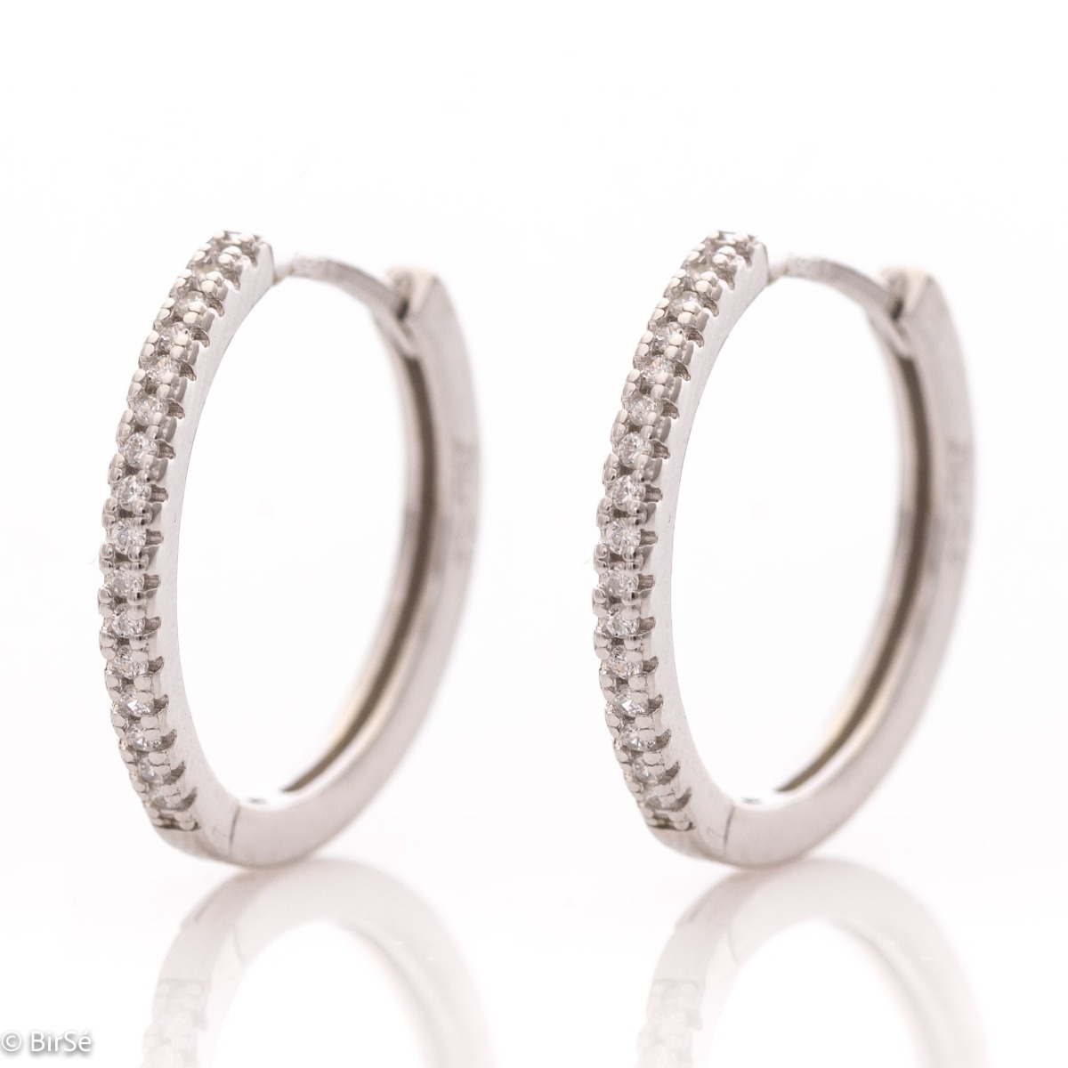 A stylish model of women's earrings - rings, with an elegant design, completely formed by combining rhodium-plated silver with shiny zircons. The fastening is English - comfortable and practical. A wonderful mood for your everyday life with BirSe earrings