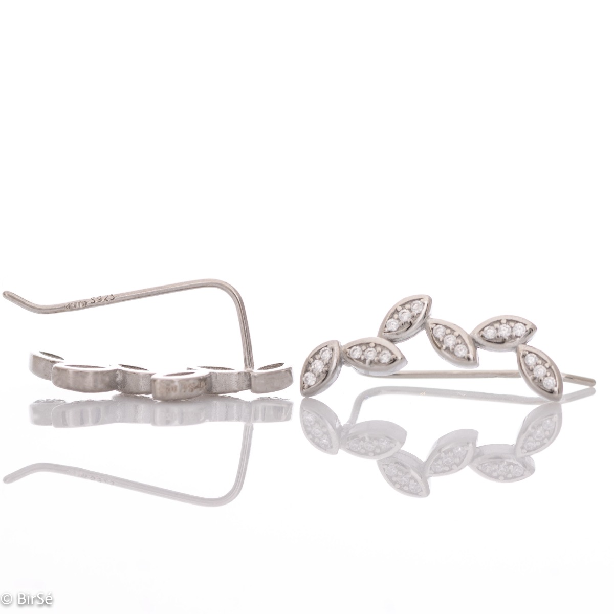 Delicate earrings of fine rhodium silver, with masterly shaped petals of glittering zircons.