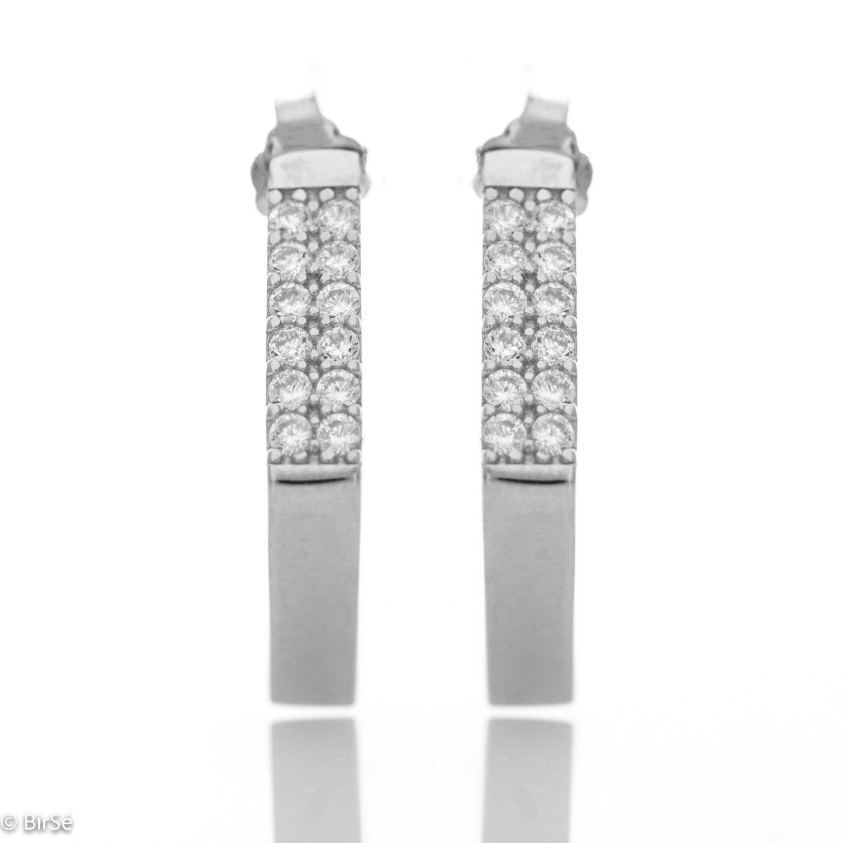 Charming earrings in fine rhodium silver, with cubic elements decorated with sparkling zircons.