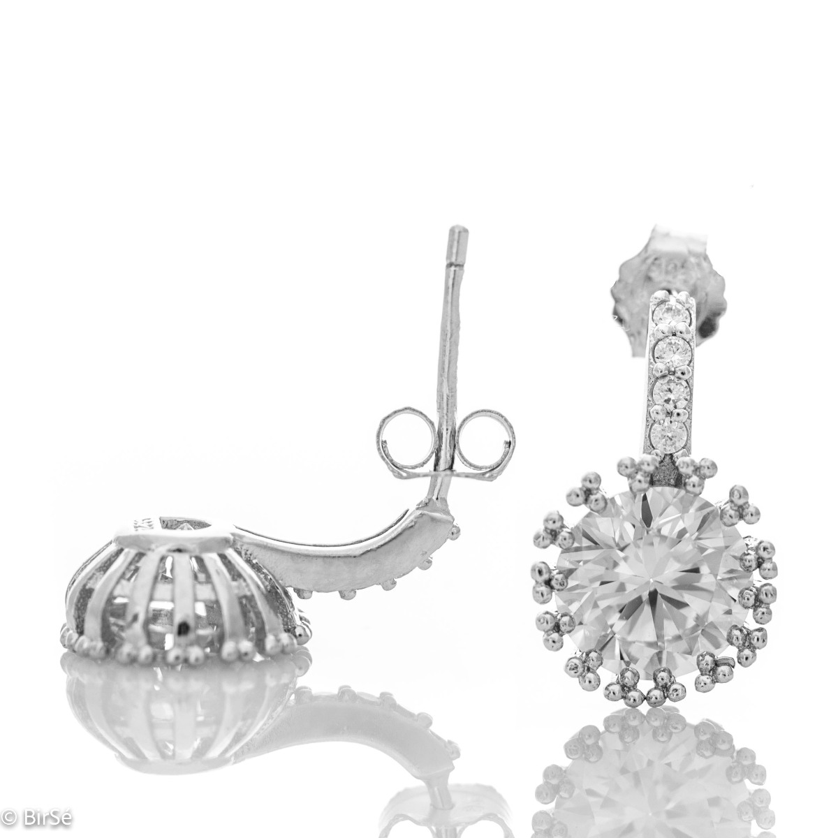 Elegant earrings in fine rhodium silver with a stylish design and a central sparkling zircon. The earrings have a pin fastening - practical and secure.