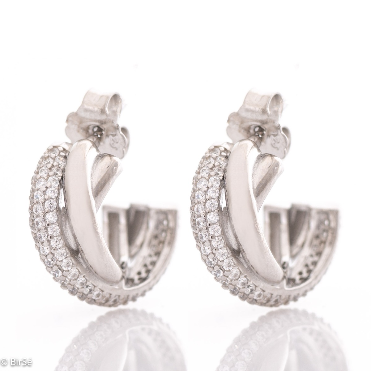 Stylish earrings with a delicate half hoop design, braided elements of rhodium silver, decorated with sparkling zircons. The earrings have a pin fastening - practical and secure.