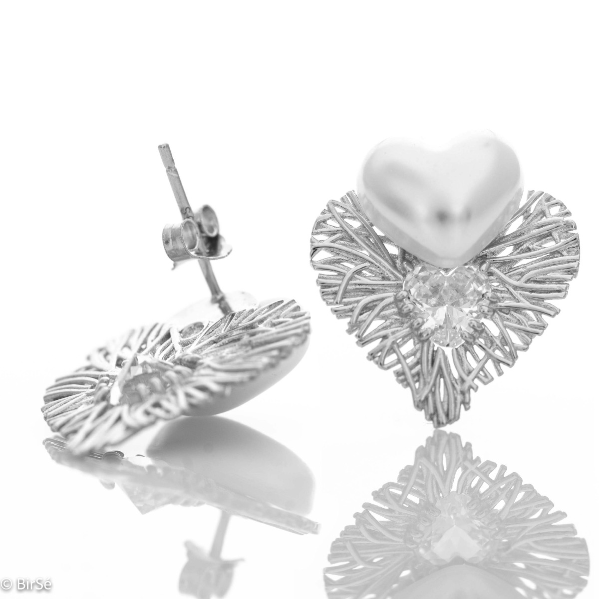 Longing and dreaming of love expressed in the new BirSe earrings. Crafted from fine rhodium silver, an openwork heart gently wraps around a smaller pearl heart and added cubic zirconias for added sparkle. The jewelry is a beautiful gift for the beloved wo