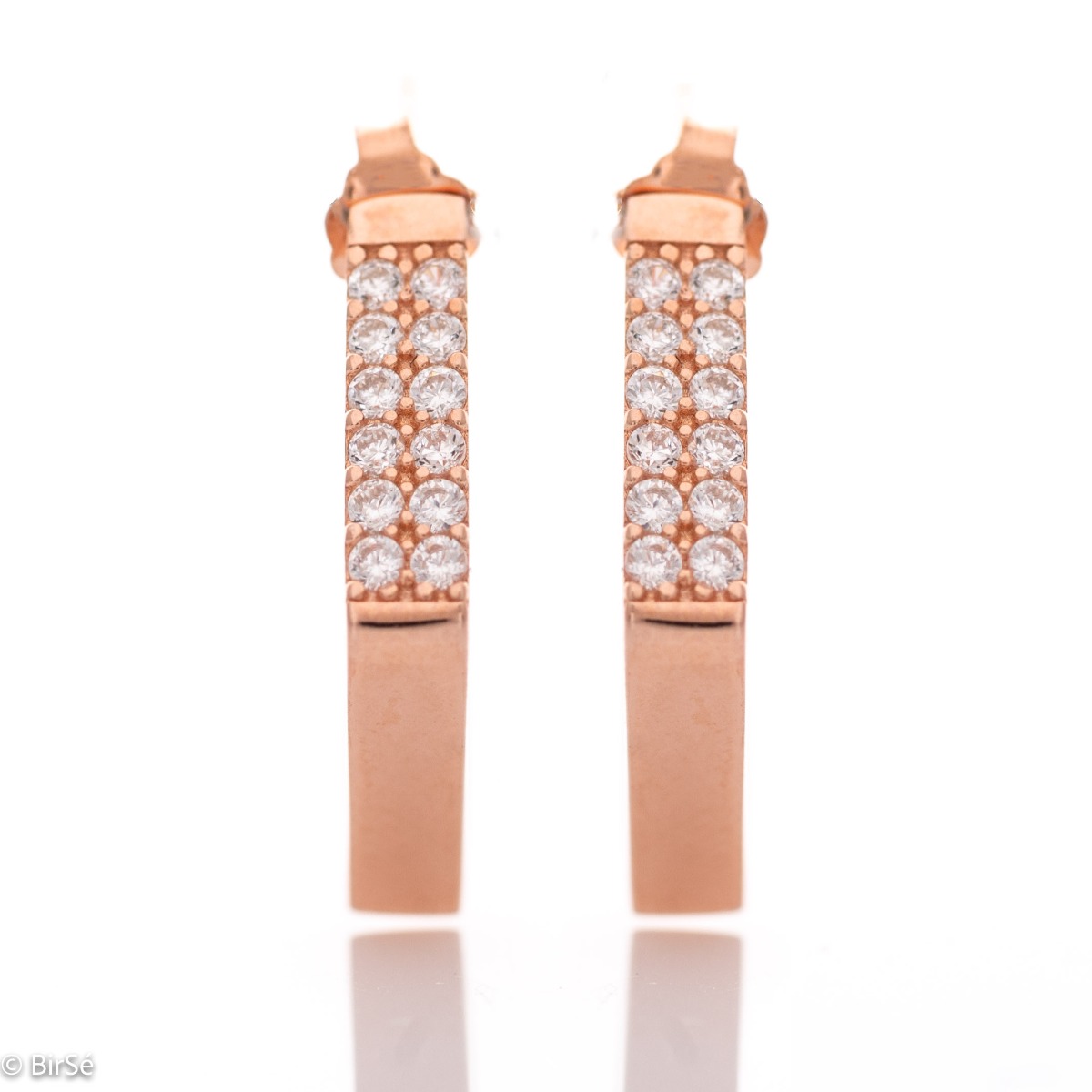 Chic earrings in fine rose silver, with cubic elements decorated with sparkling zircons. Pin fastening - comfortable and preferred by ladies.