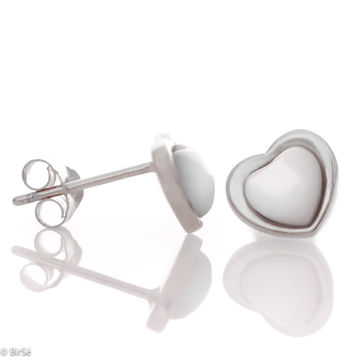 Elegant women's earrings made entirely of fine rhodium-plated silver in the shape of a heart. Their core is shaped from a beautiful milky white stone, and the fastening is with a pin.