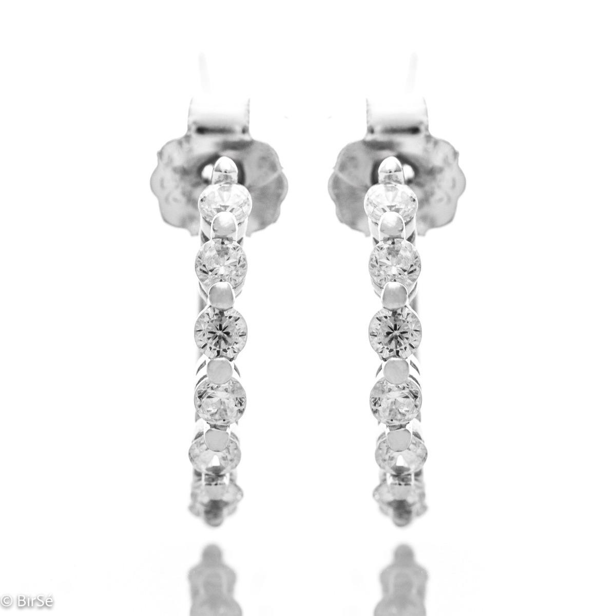 Charming women's earrings made entirely of fine rhodium-plated silver in the shape of a half-ring. Elegantly decorated with fine zircons and the fastening is with a pin.