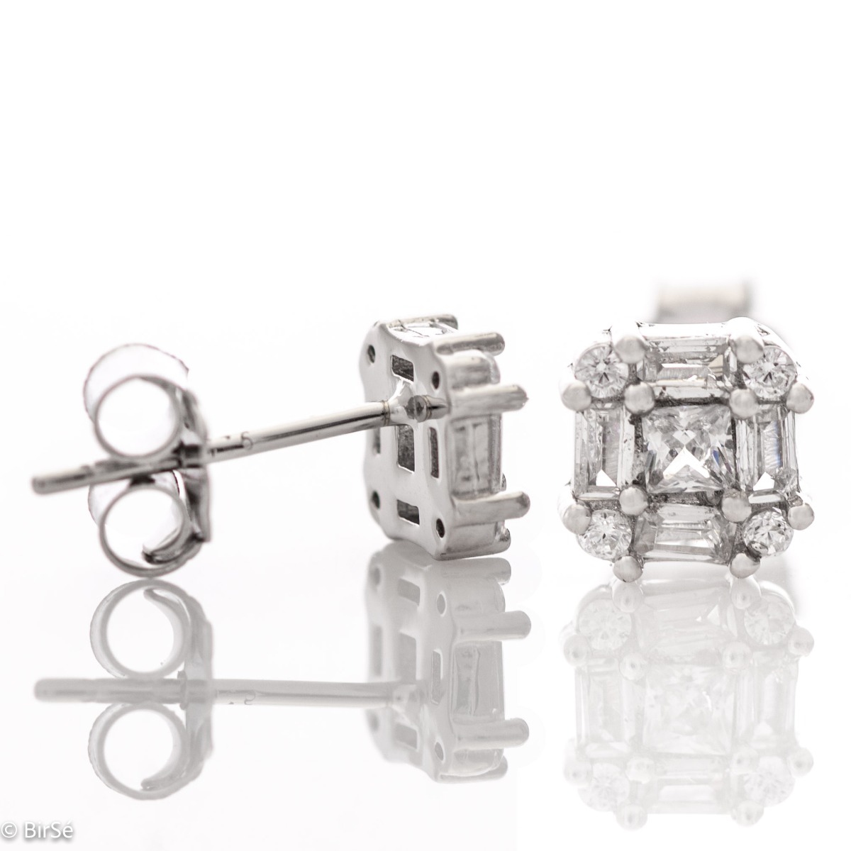 Captivating earrings "Women's caprice" made entirely of fine rhodium silver and fine zircons of various shapes. The fastening is with a pin, and the earrings are suitable for any style and outfit.