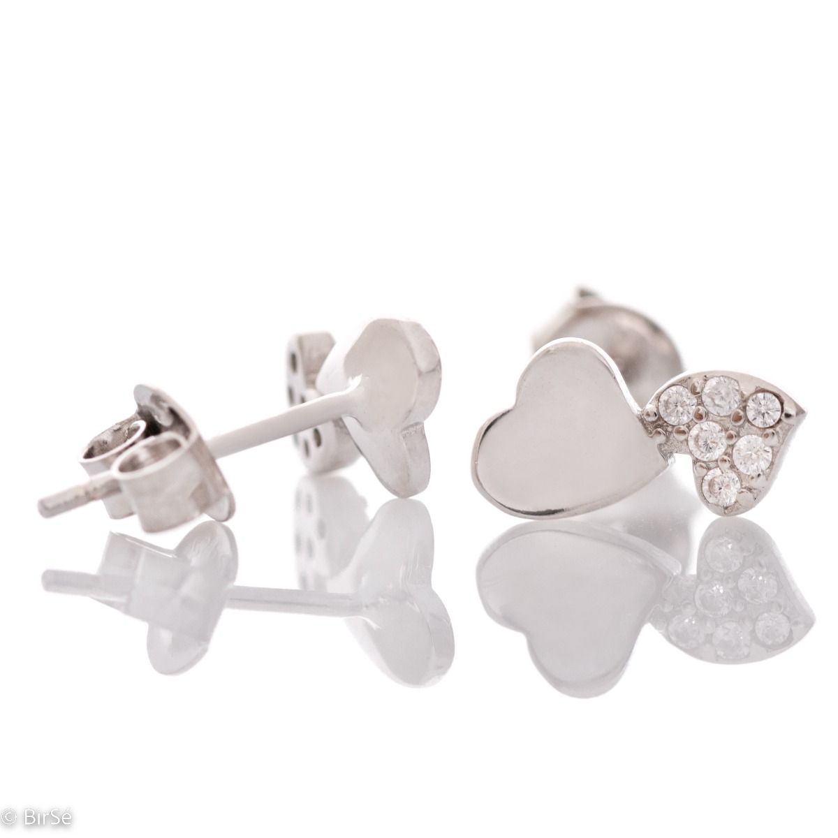 Exquisite earrings made of fine silver in the shape of a heart, in a delicate combination with sparkling zircons. Fastening with a pin is for more convenience, and the earrings are a suitable gift for the beloved girl