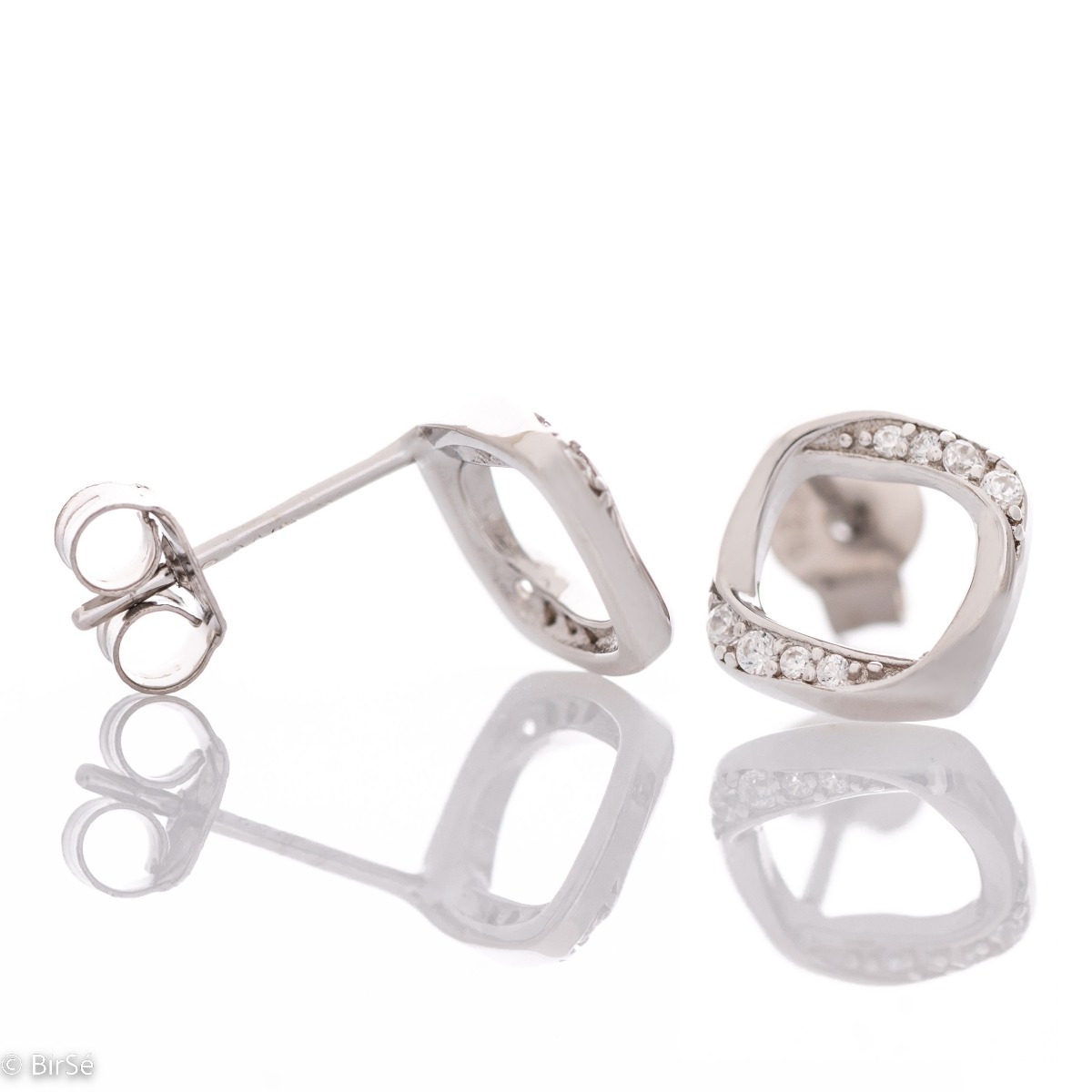 Charming earrings with a delicate design, made of rhodium-plated silver, combined with fine sparkling zircons. The pin fastening is secure and comfortable, and the earrings make a suitable gift for any lady.