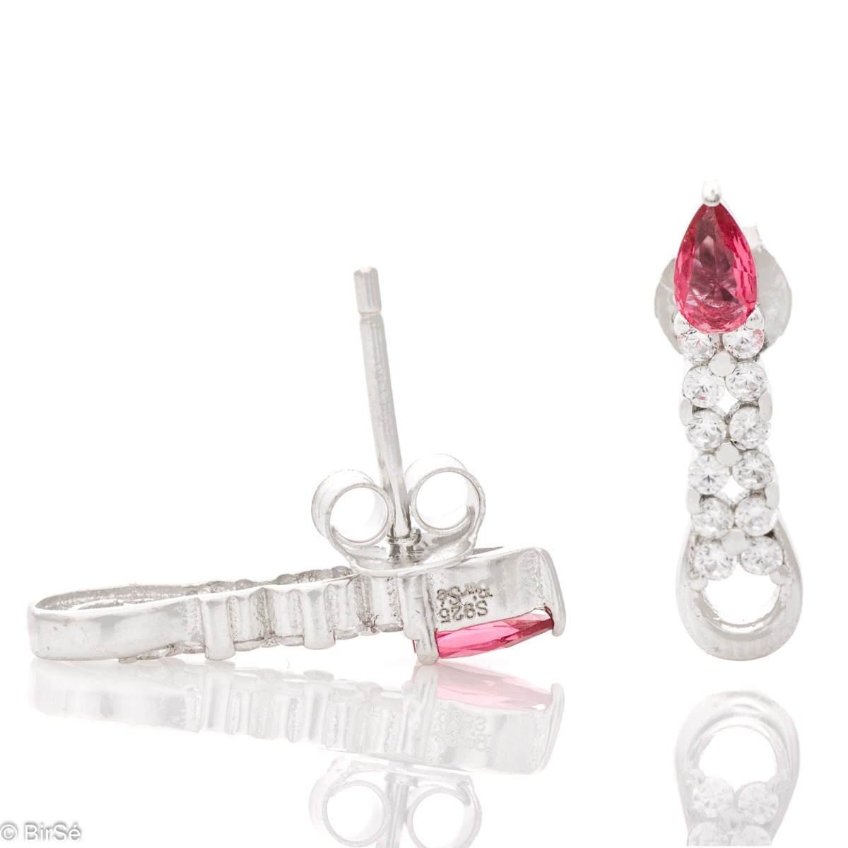 Elegant women's earrings made of soft rhodium-plated silver. A ruby-colored drop zircon is the main accent in the jewelry, in the company of more sparkling zircons. Pin fastening is convenient and practical.